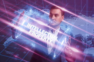 Business, Technology, Internet and network concept. Young businessman working on a virtual screen of the future and sees the inscription: Intellectual property