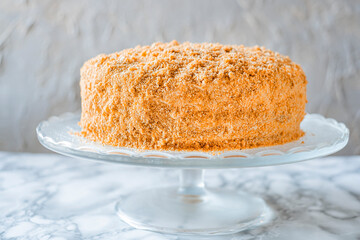 Sweet homemade honey cake on light background