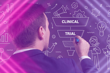 Business, Technology, Internet and network concept. Young businessman working on a virtual screen of the future and sees the inscription: Clinical trial