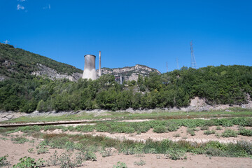 View of the Cercs thermal power plant. Electricity production industry. Surrounded by nature and mountains.