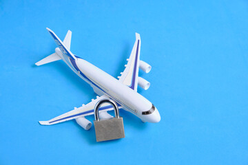 Passenger plane and lock on blue background.Concept of ban passenger flights.