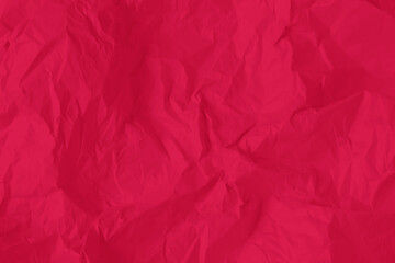 Crumpled paper Viva Magenta color of the year 2023. Texture crumpled paper for your design. Copy space. Viva Magenta color paper.