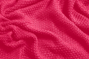 Fototapeta na wymiar Viva Magenta toned colour monochrome texture knitted fabric. Dark pink knitted Jersey as textile background. Monochrome color background. Wool knitting texture. Trendy color 2023.