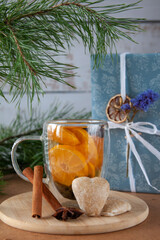Gingerbread in the shape of a heart, warm citrus vitamin tea with spices, gift. A hint of happiness and love in the coming new year 2023