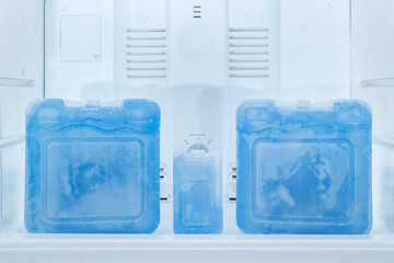 Blue ice packs in refrigerator freezer
