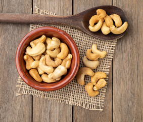 Cashew nuts in a bowl over wooden table