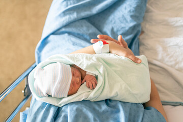 Mother with her newborn baby at the hospital a day after a natural birth labor