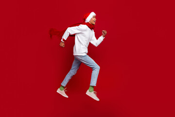 Full size profile portrait of energetic overjoyed guy run jump look empty space isolated on red color background