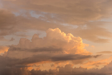 orange and blue sky background in the evening or dusk.Natural beautiful bright saturated landscape view of sky sunrise or sunset with yellow orange red lilac clouds flying.