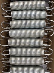 a bunch of stainless steel springs with hooks