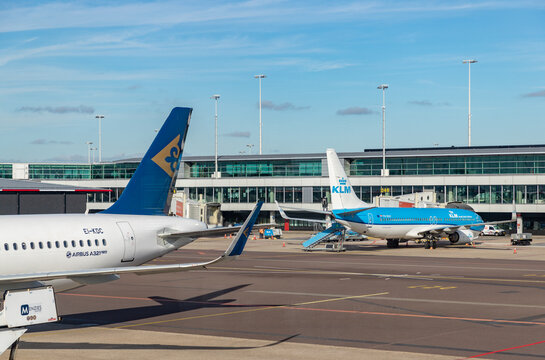 Amsterdam, Netherlands - October 19, 2022: A picture of a KLM and an Astana plane in the Schiphol Airport.