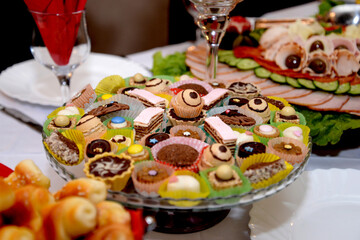 mixed  homemade sweets on a glass platter, party food 