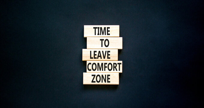 Leave comfort zone symbol. Concept words Time to leave comfort zone on wooden blocks. Beautiful black table black background. Business time to leave comfort zone concept. Copy space.