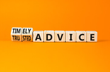 Timely or trusted advice symbol. Concept words Timely advice and Trusted advice on wooden cubes. Beautiful orange table orange background. Business timely or trusted advice concept. Copy space.