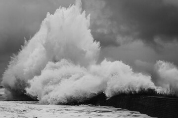 Monumental Black and White Wave Crashing on Harbor Pier