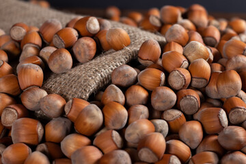 close up of hazelnuts on wooden table, top view