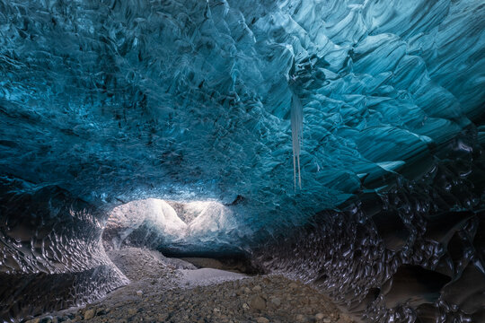 Blue ice cave with icicles in Iceland