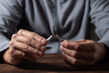 Cigarette. World No Tobacco Day Concept. Stop smoking cigarettes concept. Closeup man holding...