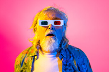 Impressed gray haired male in 3d glasses in studio