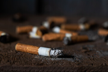 Cigarette butts on a black background. Cigarette butts. Cigarette