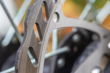 Bicycle disk brakes close up, grey metal disc attached to bike wheel, effective popular mountain...