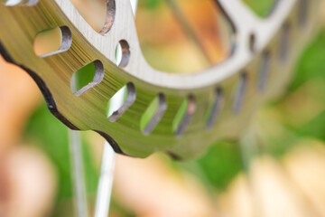 Bicycle disk brakes close up, grey metal disc attached to bike wheel, effective popular mountain...