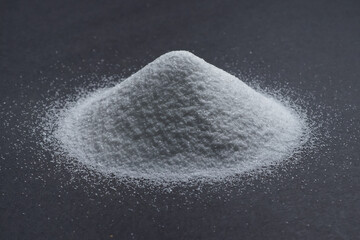 White quartz sand on a gray background in the form of a slide.