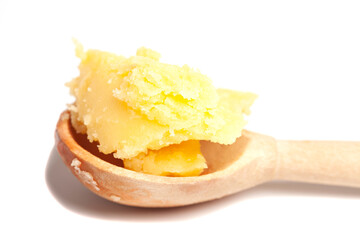 Ghee in wooden spoon isolated on white background