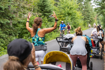 Female cardio instructor giving cardio and aerobic lessons to group of new mothers with their...