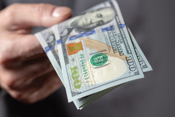 American 100 dollars bank note in hand close up