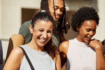 Laughing friends walking together outside after the gym