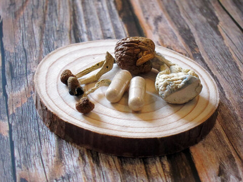 Psilocybin Psilocybe Psilocybin Psilocybe psychedelic magic mushrooms and microdose capsules on wood golden teachermagic mushrooms and microdose capsules on wood golden teacher