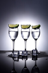 vodka with lime on grey background