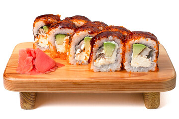 rolls on a wooden plate with sesame and avocado 