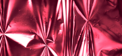 Photo of crumpled foil texture in trendy viva magenta color