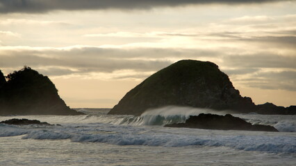 Islet silhouetted in the sunrise in Zipolite, Mexico