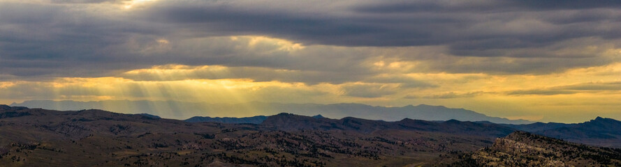Fototapeta na wymiar Drone aerial view of a sunset amongst the hills and mountains outside of Cody, Wyoming