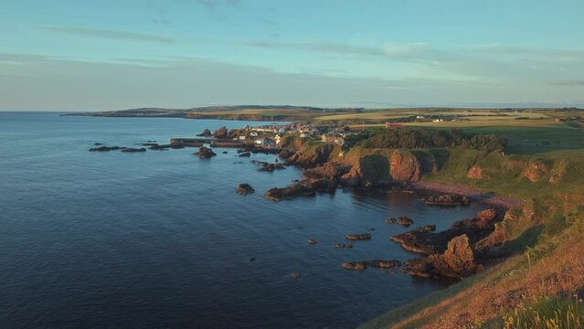 The south east coast of Scotland lit up by the morning sunshine. Video with the forward camera motion. Village of St. Abbs, Starney Bay - Nature Reserve, Berwickshire, Scotland, UK 