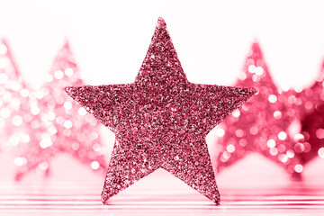 Textured glittering red stars on white background. Demonstrating Viva Magenta - trendy color of the year 2023