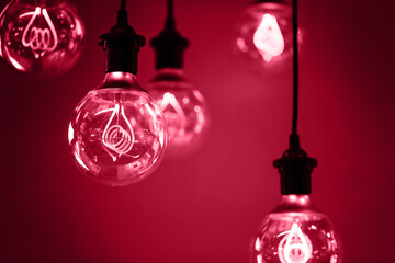 Group of red lamps with interesting shape of tungsten filament and red light. Demonstrating Viva Magenta - trendy color of the year 2023 - 550914722