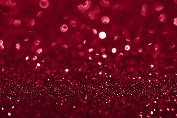 Red glitter bokeh background. Festive and sparkling. Demonstrating Viva Magenta - trendy color of the year 2023