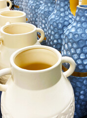 Beige and blue ceramic jugs close-up photography.