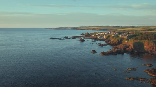 The south east coast of Scotland lit up by the morning sunshine. Video with the panning camera motion. Village of St. Abbs, Starney Bay - Nature Reserve, Berwickshire, Scotland, UK 