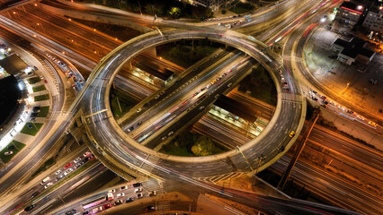 Aerial drone slow shutter night photo of illuminated urban elevated toll ring road junction and interchange overpass passing through Kifisias Avenue, Attica, Greece