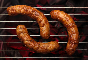 Grilled sausages with a perfect char, ready to be enjoyed off the barbecue, embodying the essence of outdoor cooking.