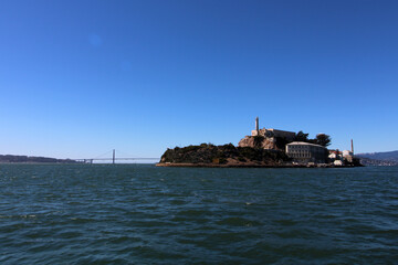 Alcatraz Island and Golden Gate Bridge on sunny day in San Francisco