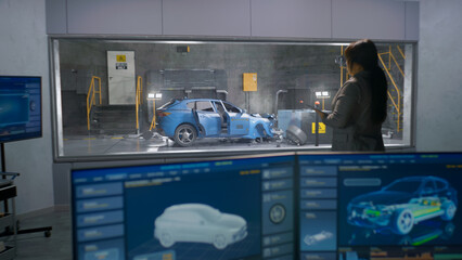 Engineer in experimental crash test laboratory watching process of traffic accident simulation, to...