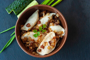 national Ukrainian dish, traditional varenyki with potatoes, cabbage, crackers made of lard and fried onions, food of the countries of the world, gastrotourism, culture of Ukraine