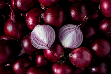raw cut onion on a pile of purple onions