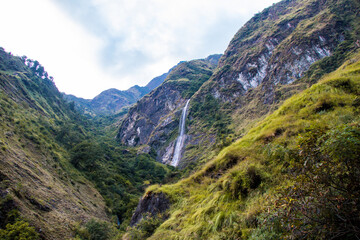 Fototapeta na wymiar Trekking in the Himalaya mountains of Nepal with beautiful green hills, river and waterfalls